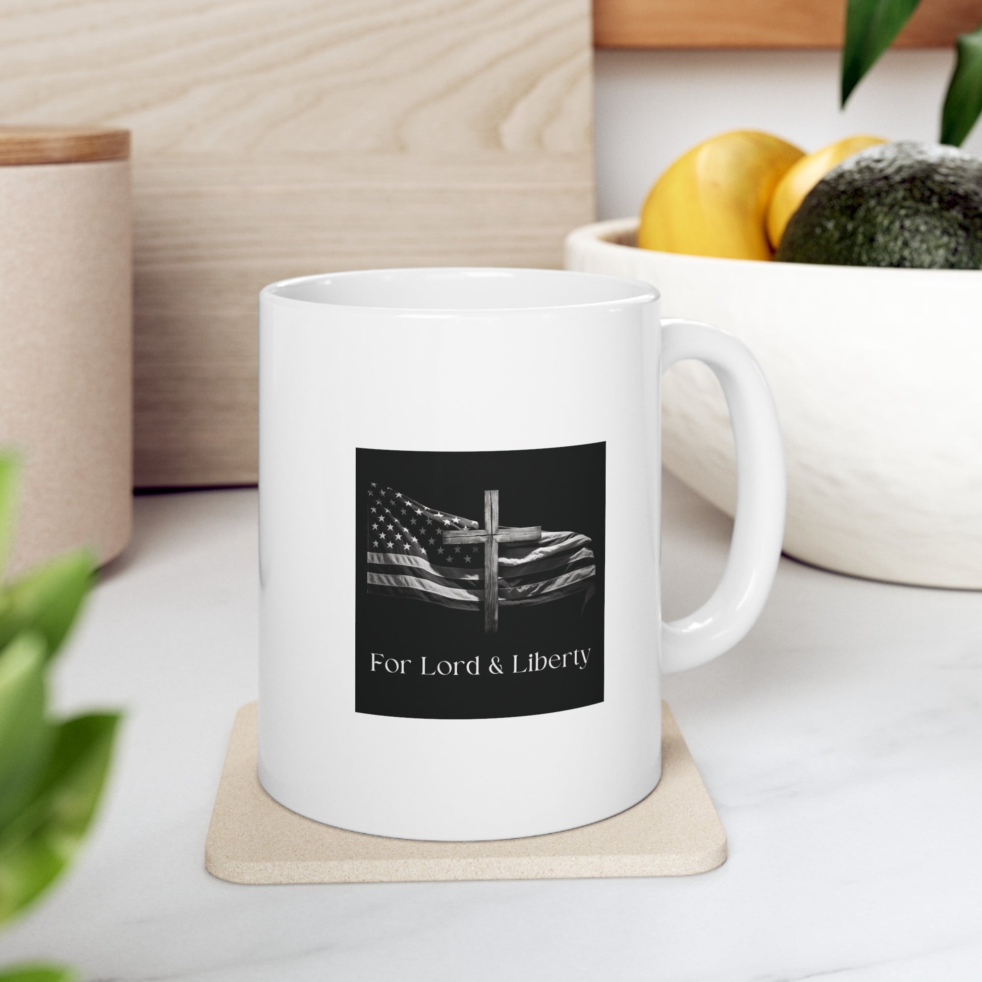 a white mug with the for lord and liberty logo on the front of the mug sitting on the kitchen counter