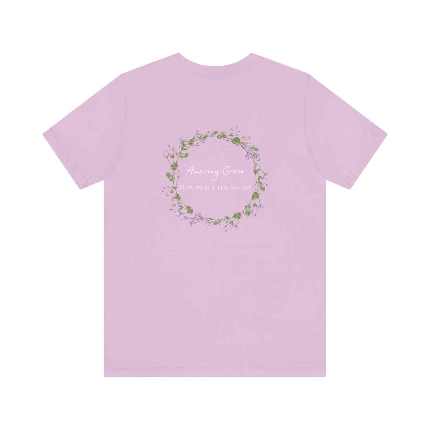 A lilac t-shirt with the words Amazing Grace how sweet the sound on the back of a t-shirt surrounded by a flower wreath