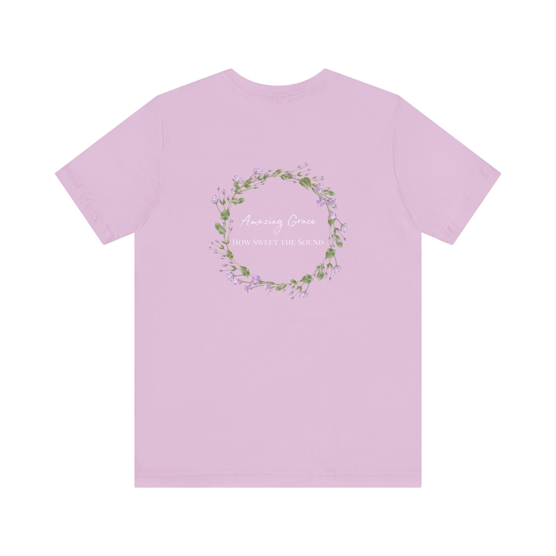 A lilac t-shirt with the words Amazing Grace how sweet the sound on the back of a t-shirt surrounded by a flower wreath