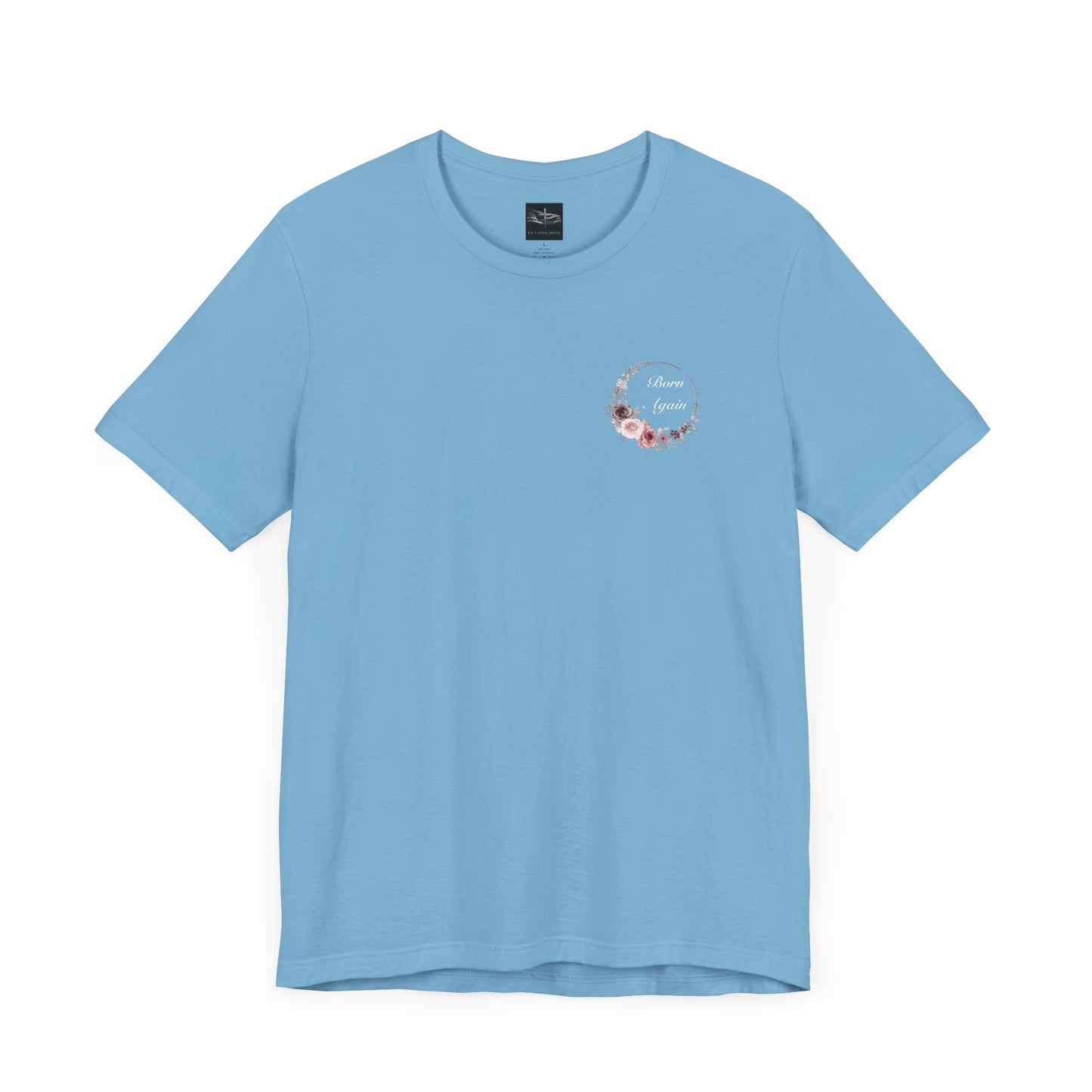 A ocean blue t-shirt with the words Born Again with a flower wreath on the front left pocket