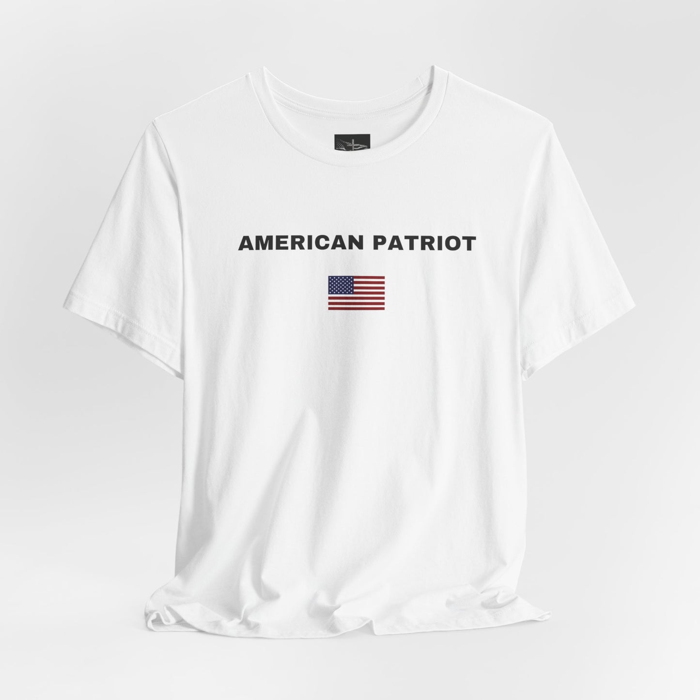 A white t-shirt with the words American patriot in black letters with an American flag