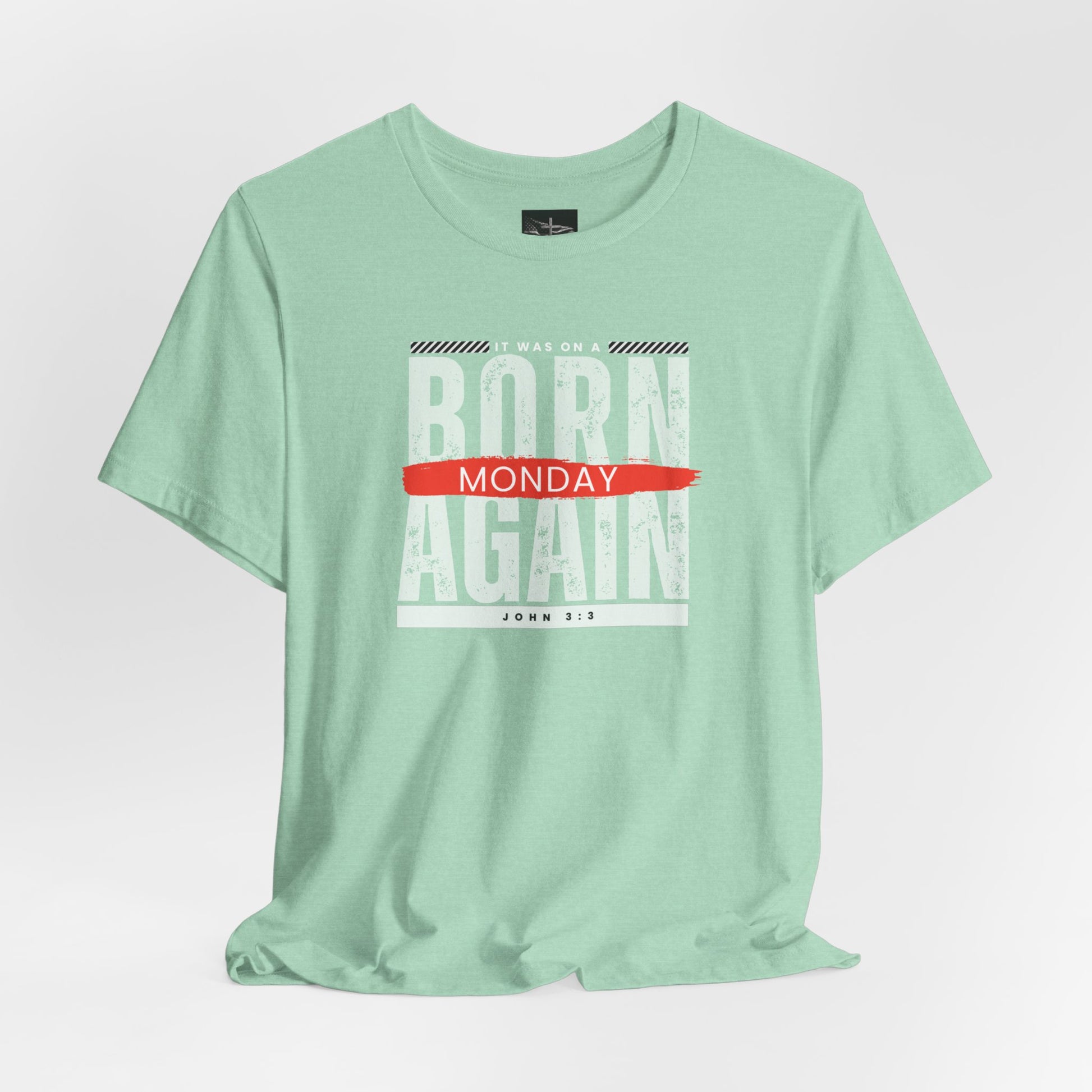 A green t-shirt with the words Born Again it was on a Monday with the scripture John 3:3