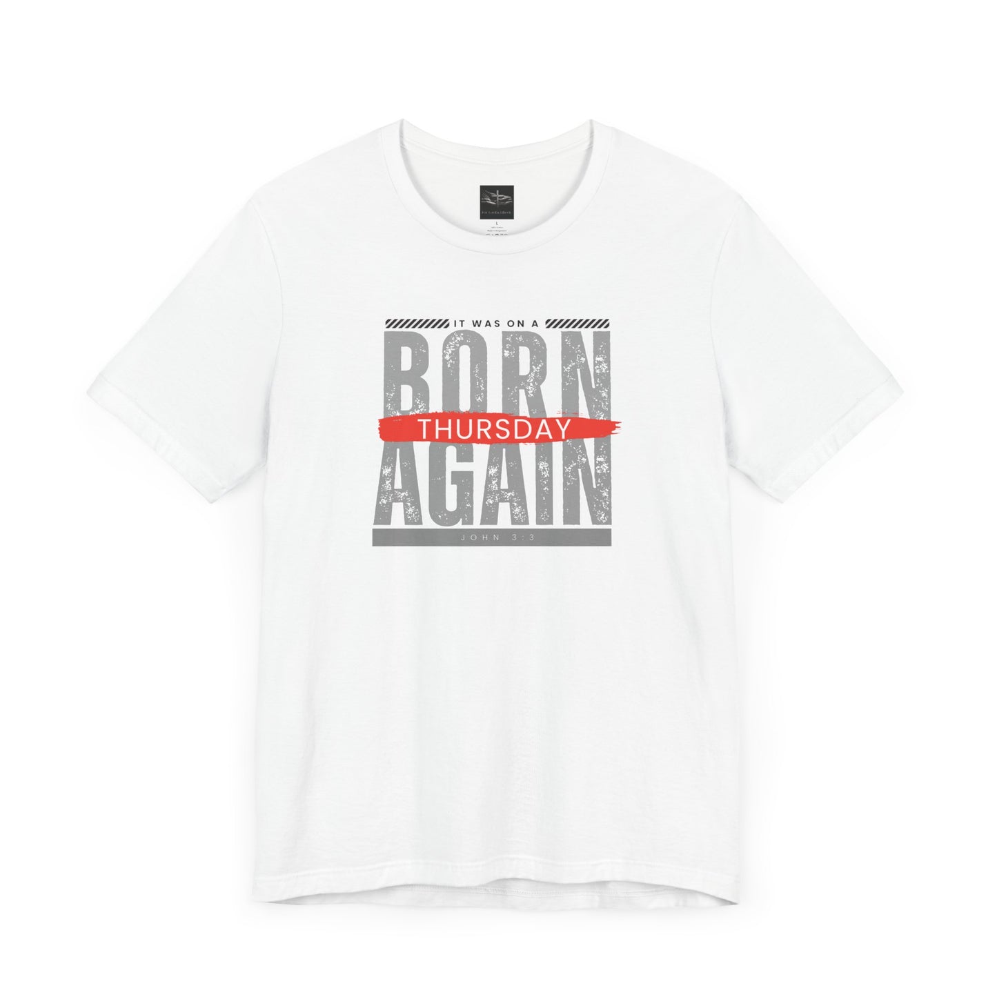 A white t-shirt with the words Born Again it was on a Thursday with the scripture John 3:3