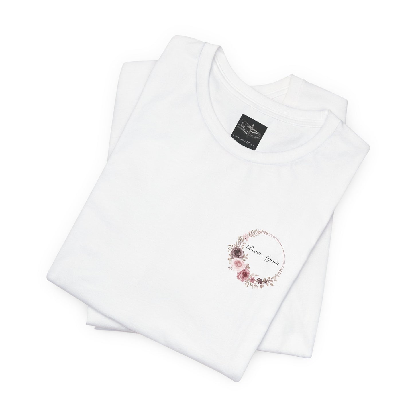 A white t-shirt with the words Born Again surrounded by a flower wreath with a for lord and liberty t-shirt tag