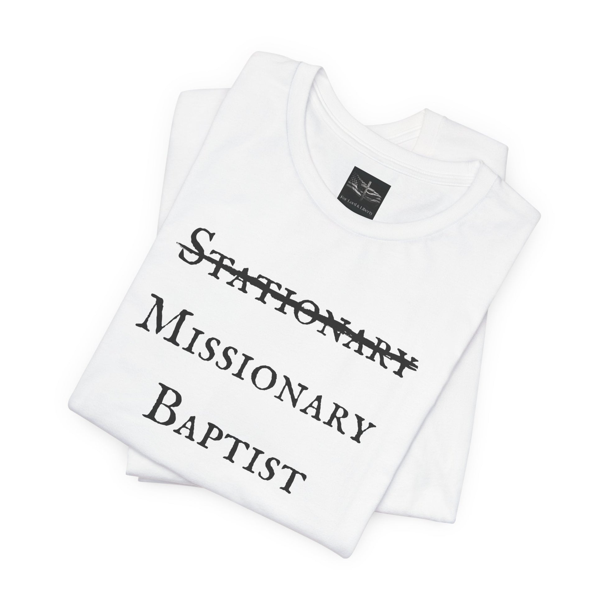 A white t-shirt with the word Stationary marked out with the words Missionary Baptist in bold