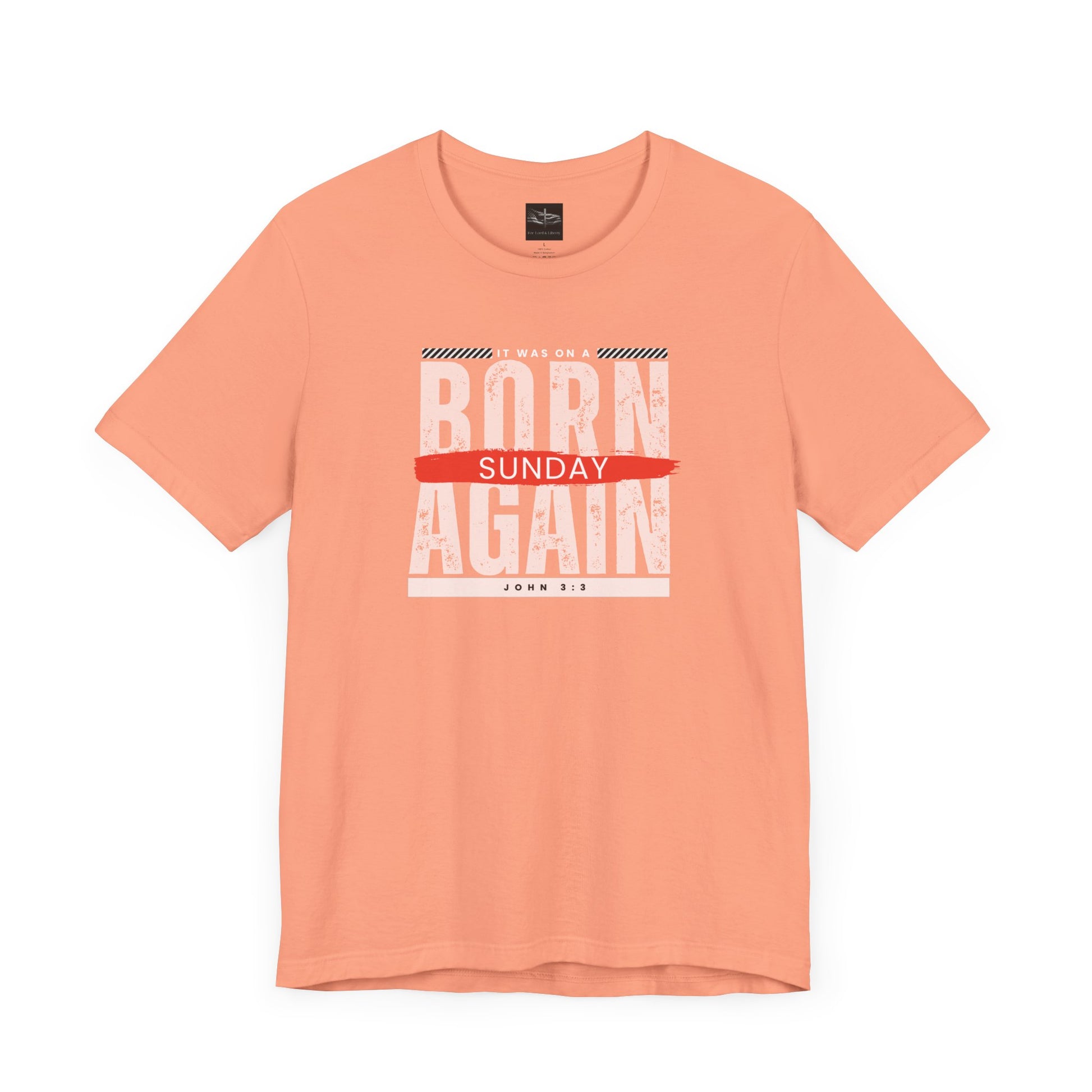 A orange t-shirt with the words Born Again it was on a Sunday with the scripture John 3:3