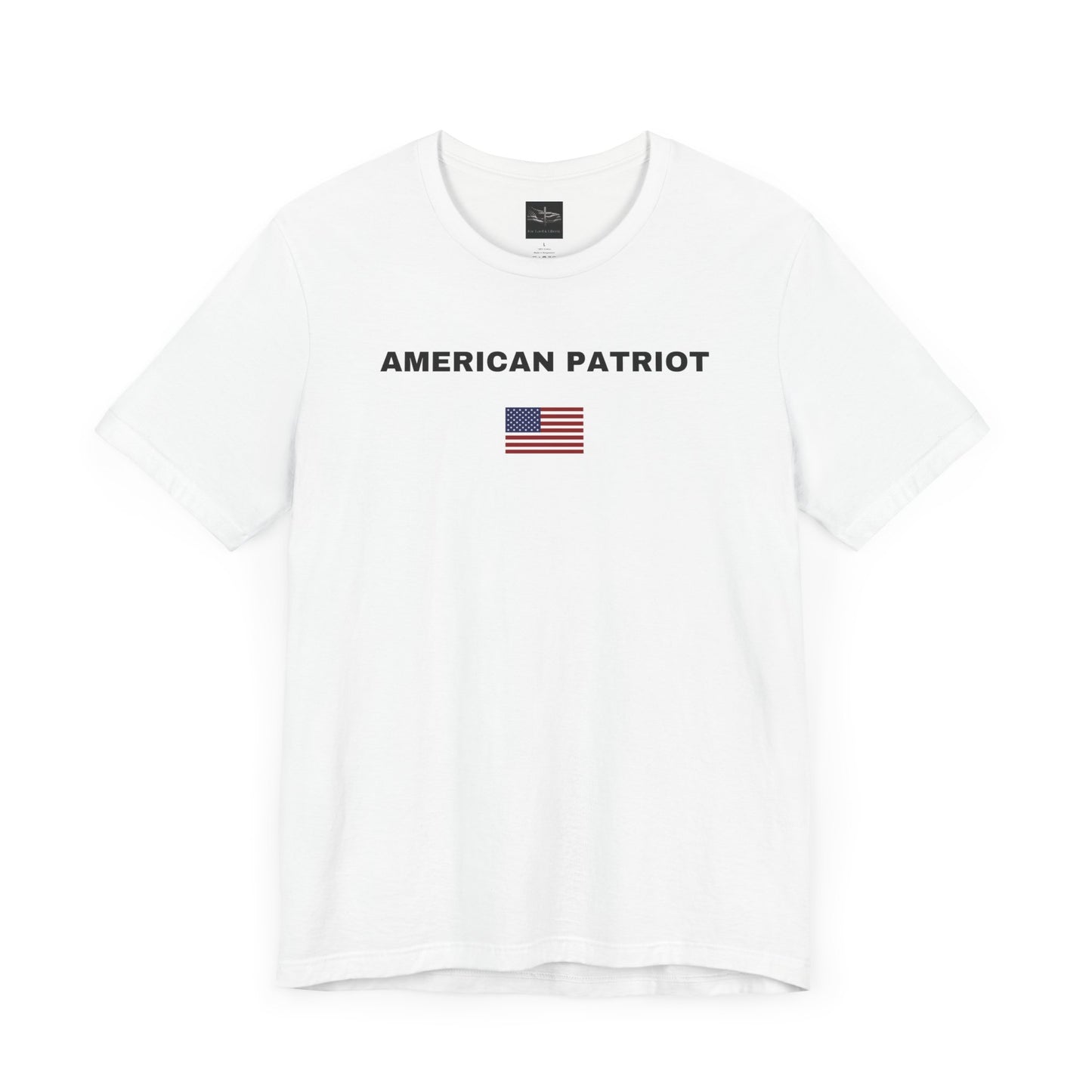 White t-shirt with the words American Patriot in black and an American flag