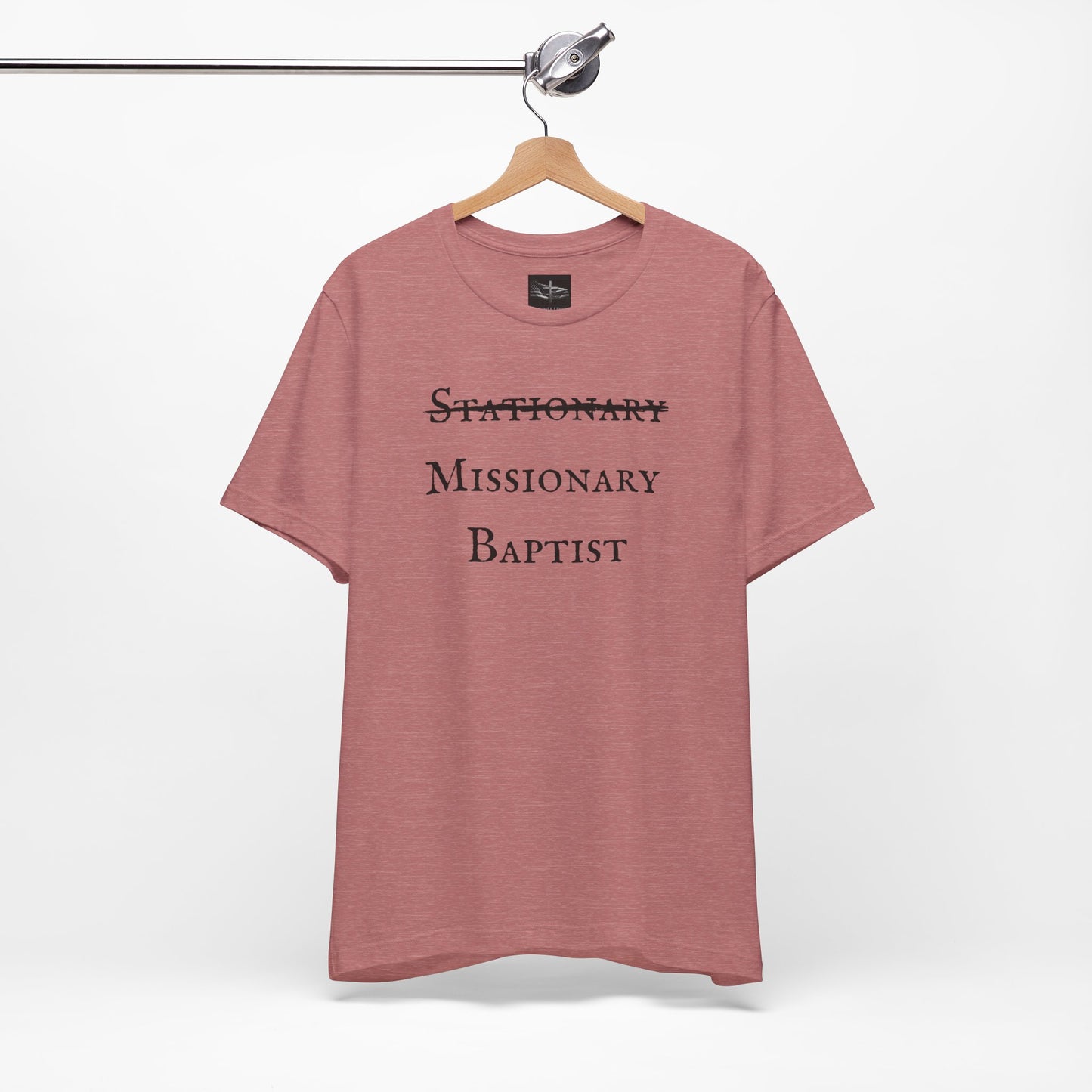 A heather muave t-shirt with the word Stationary marked out with the words Missionary Baptist in bold