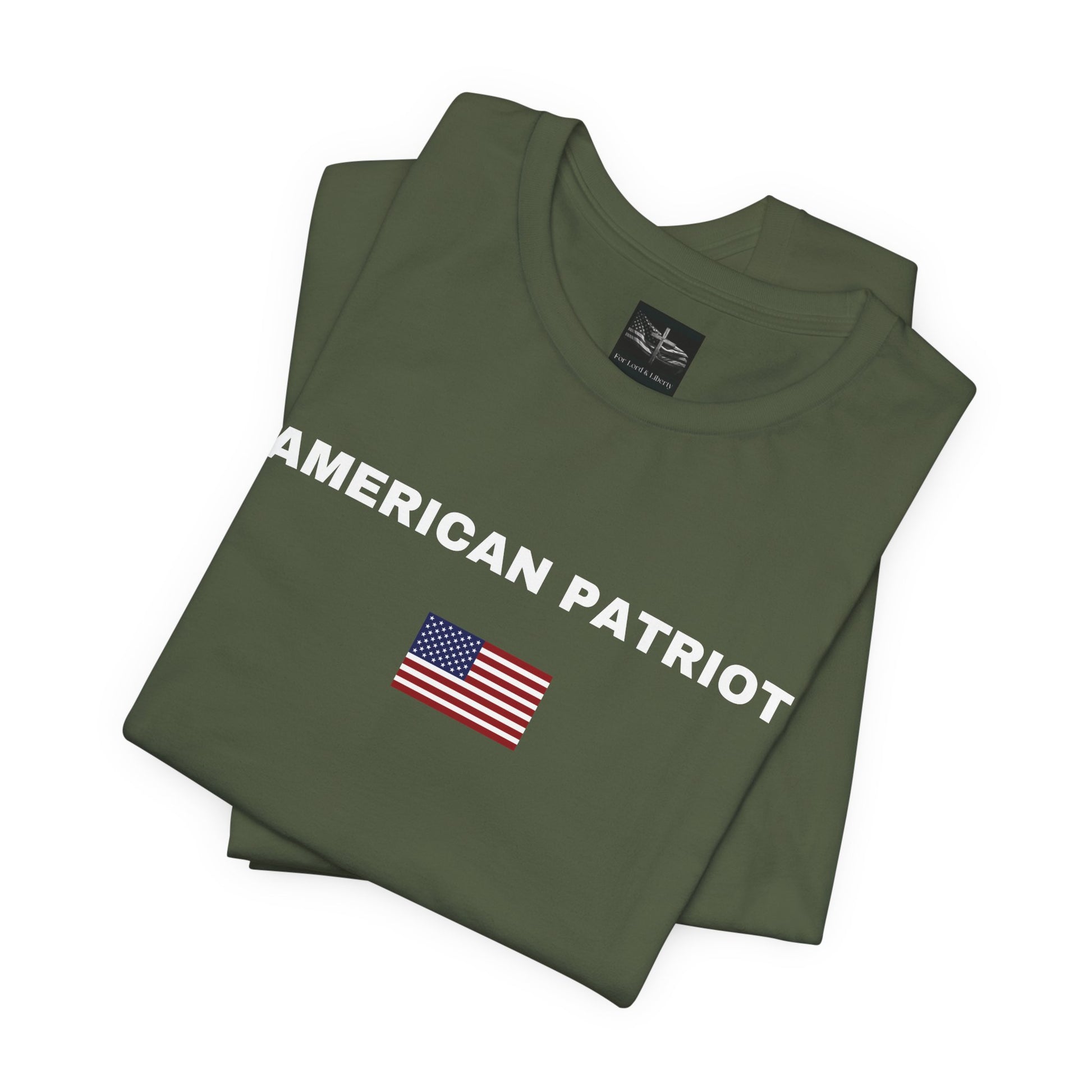 A military green t-shirt with the words American Patriot in white letters with an American flag