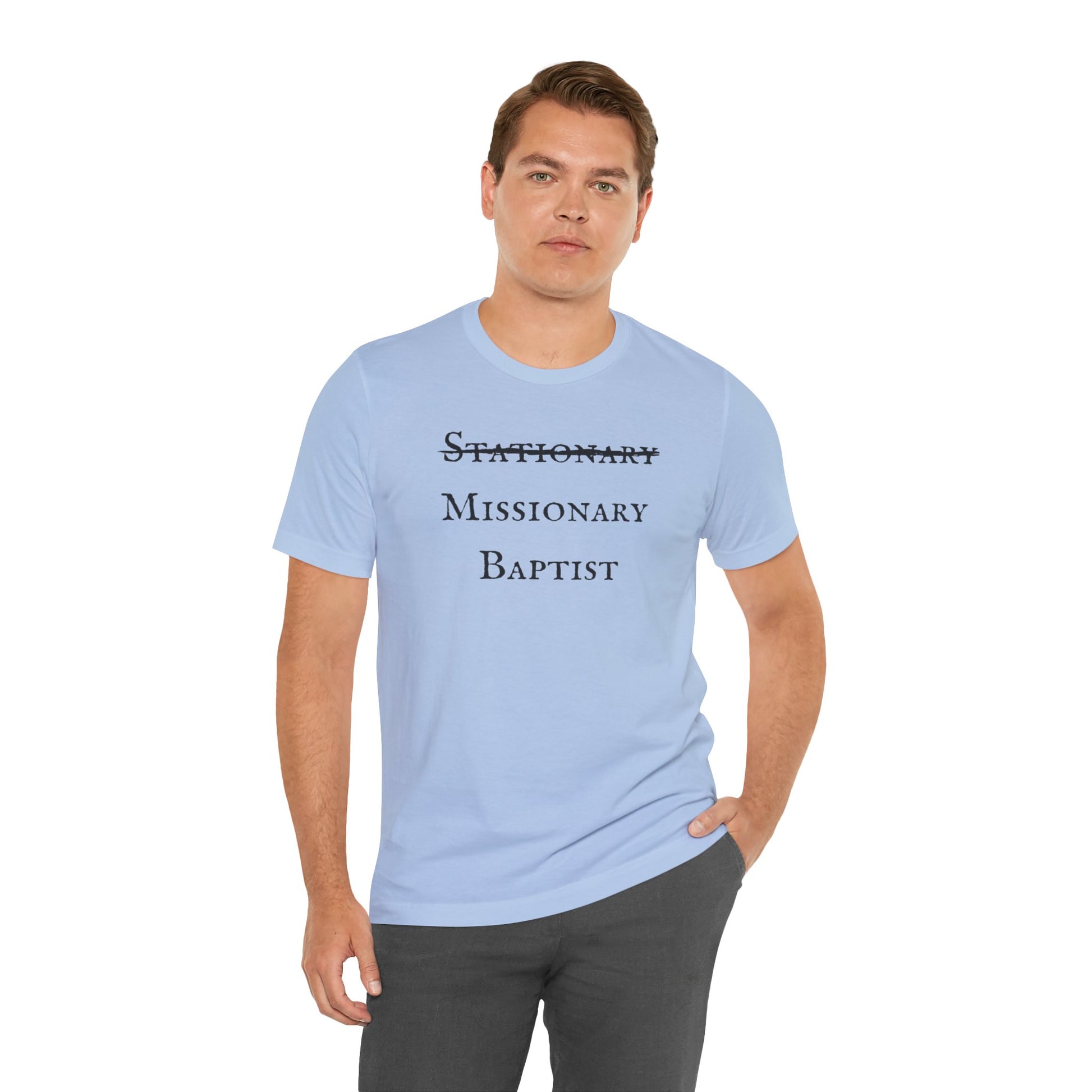 A male wearing a baby blue t-shirt with the word Stationary marked out with the words Missionary Baptist in bold