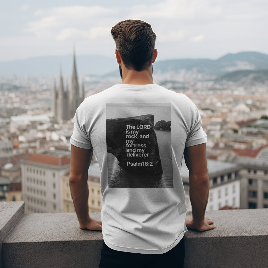 a man wearing an  ice grey t-shirt with Psalm 18:2: "The Lord is my rock, and my fortress, and my deliverer; my God, my strength, in whom I will trust; my buckler, and the horn of my salvation, and my high tower" on the back t-shirt