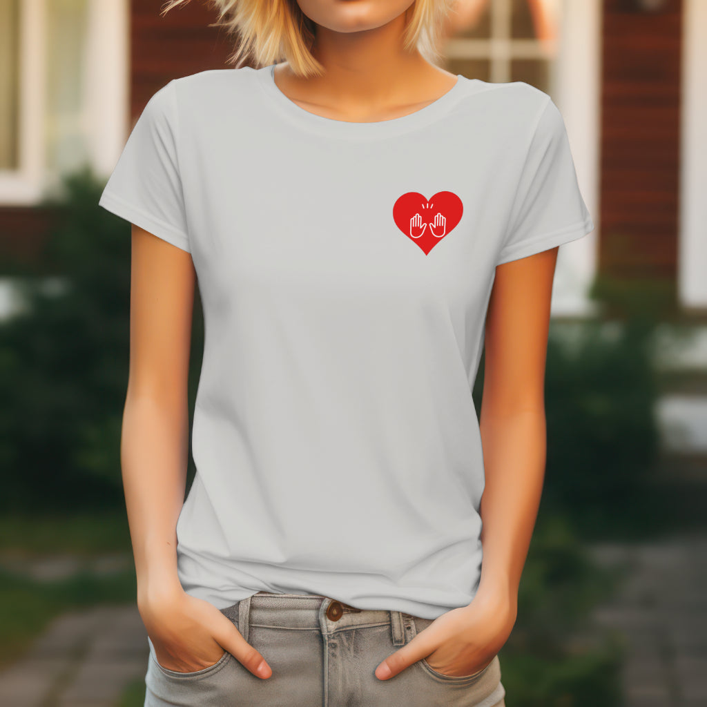 a woman wearing ice grey t-shirt with a red heart logo with praise hands