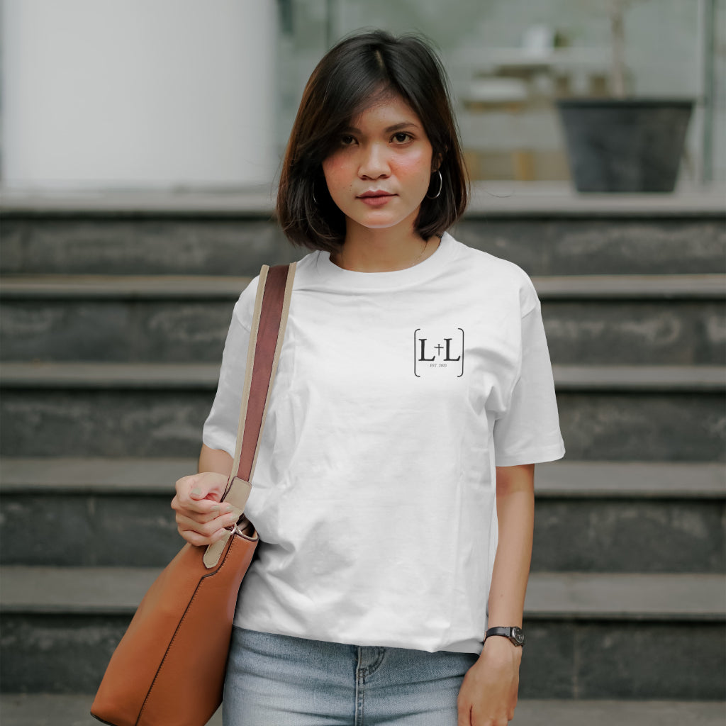 A woman wearing a white t-shirt with the for lord and liberty logo