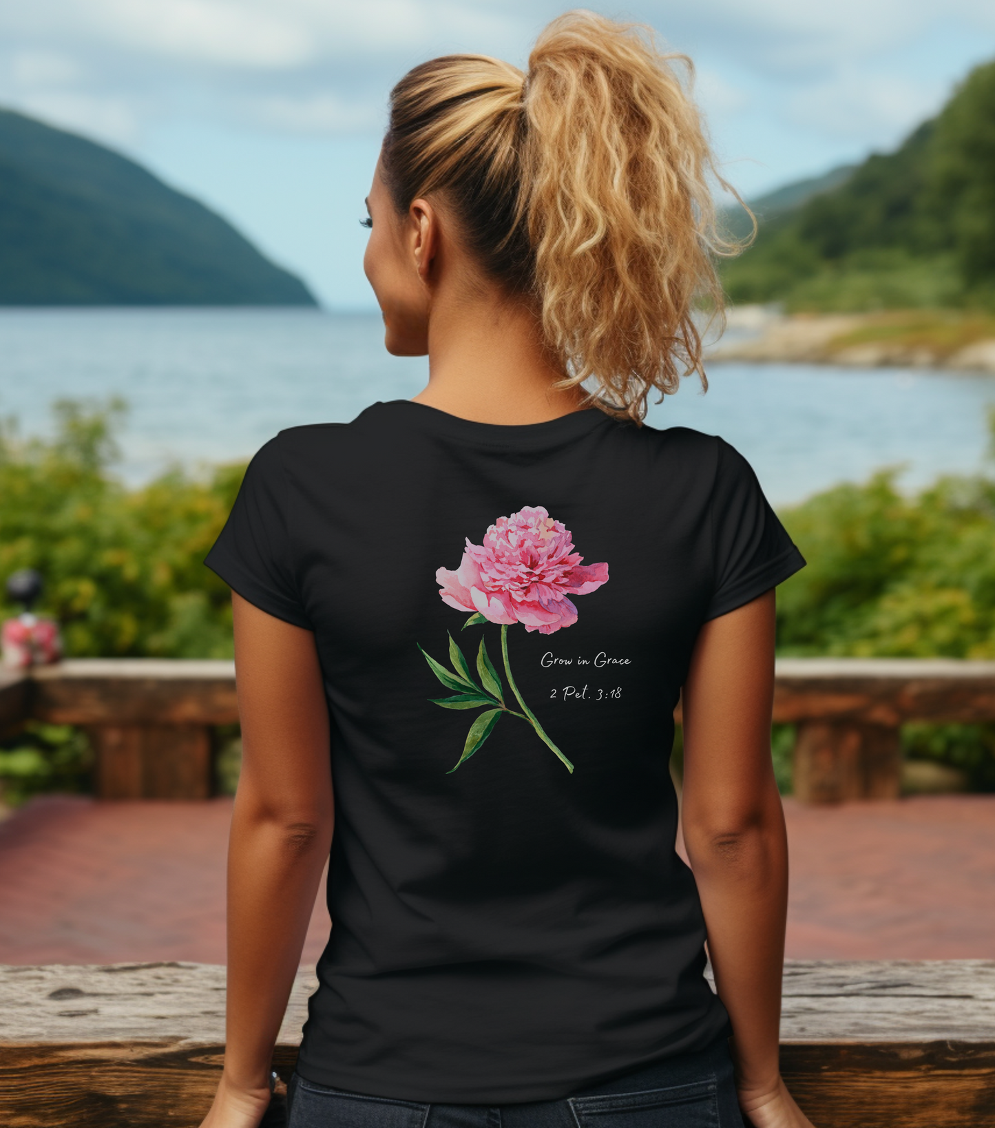 A female wearing a black t-shirt with Grow in Grace and a flower  on the back of t-shirt