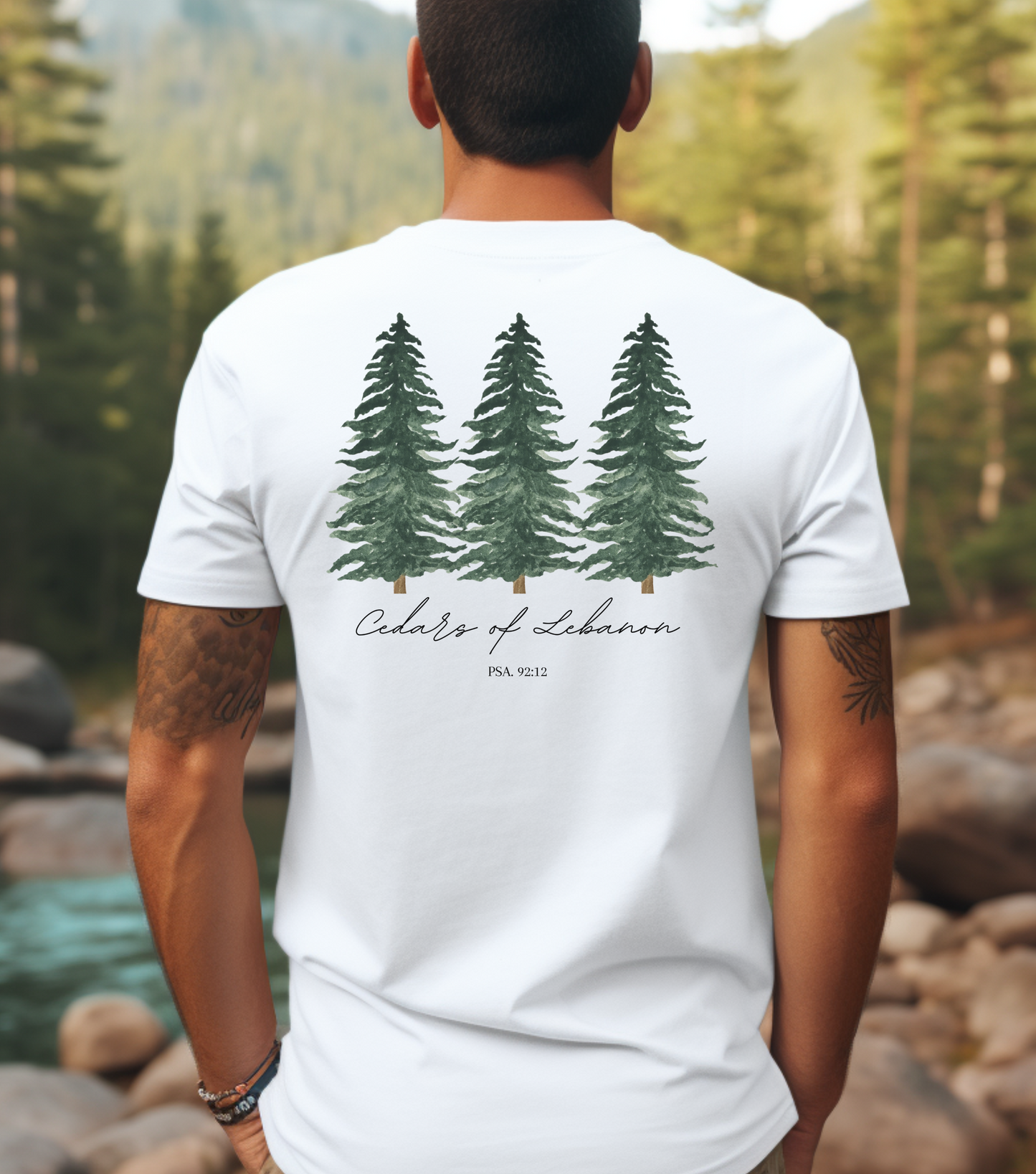 A male wearing a white t-shirt with three cedar trees and the words Cedars of Lebanon Psalms 92:12